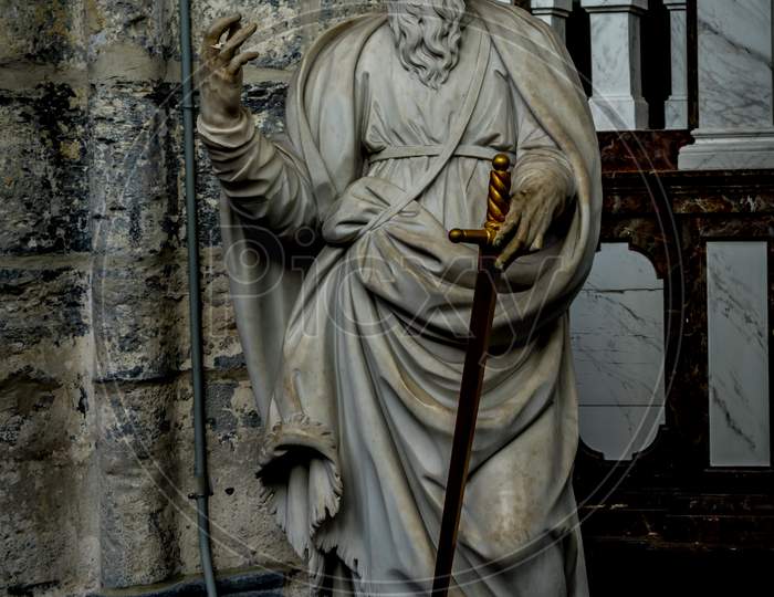 A White Marble Sculpture Of An Scholar With A Sword In The Interiors Of Saint Nicholas Church, Ghent, Belgium