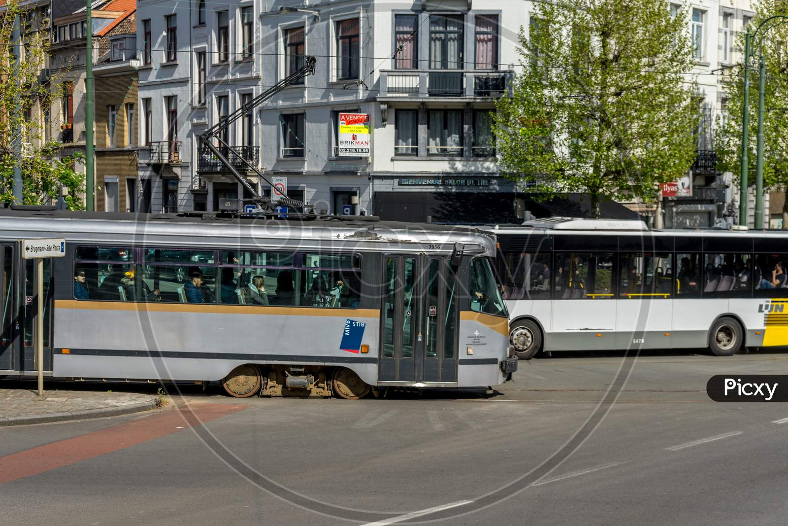 Brussels, Belgium - April 2017: A Tram And A Bus Cross Each Other In The City Of Brussels, Belgium