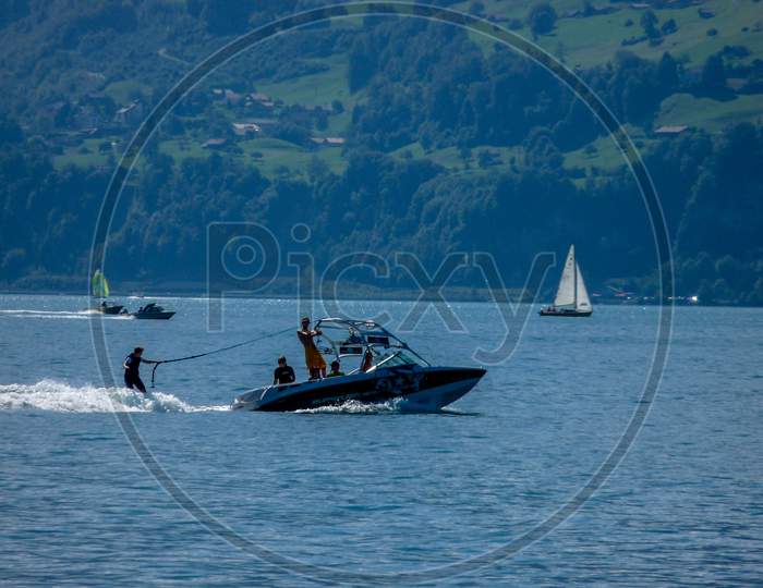Switzerland, Lauterbrunnen, People Sailing On Sailboat In Sea