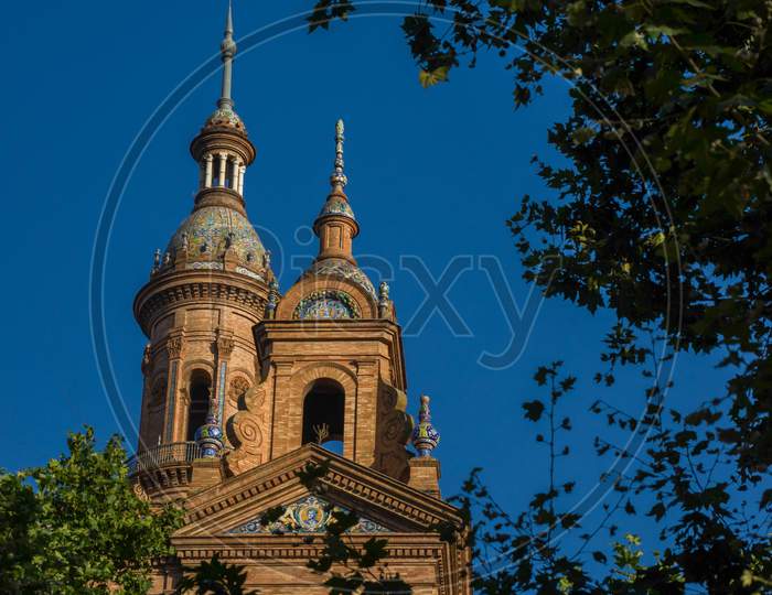 Spain, Seville, Low Angle View Of Trees And Building Against Sky At Night In Plaza De Espana