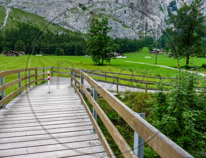 Switzerland, Lauterbrunnen, Footbridge Over Footpath Amidst Trees