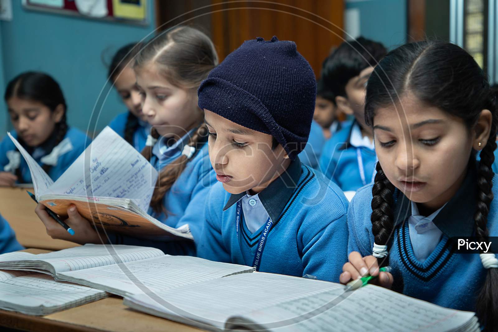 Jodhpur, Rajasthan, India - Jan 10Th 2020: Primary Indian Students Studying In The Classroom Taking Exam / Test Writing In Notebooks. Education Concept.