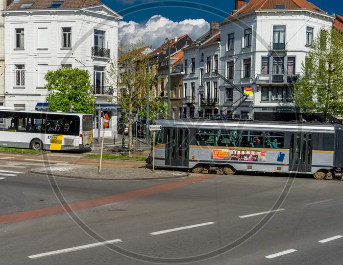 Brussels, Belgium - 17 April 2017: A Tram And A Bus Cross By Each Other On The Streets Of Brussels, Belgium