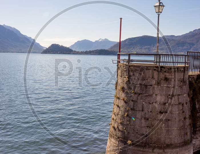 Italy, Menaggio, Lake Como, A Small Boat In A Body Of Water