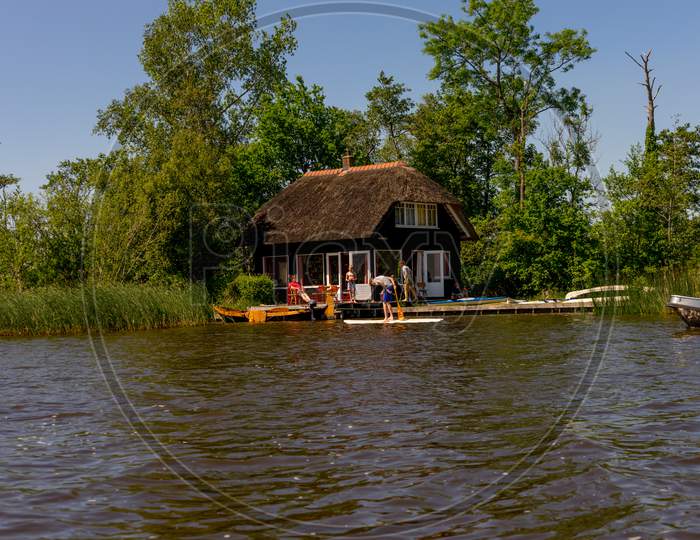 Giethoorn, Netherlands - 26 May: A Tourist Paddle On The Canal At Giethoorn On 26 May 2017. Giethoorn Is The Venice Of Netherlands