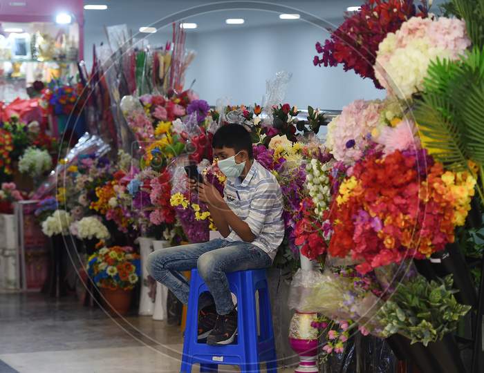 A Young Vendor Checks His A Mobile As He Waits For Customers Inside A Shopping Mall Reopened After The Government Eased A Nationwide Lockdown Imposed As A Preventive Measure Against The Covid-19 Coronavirus, In Chennai On September 1, 2020.