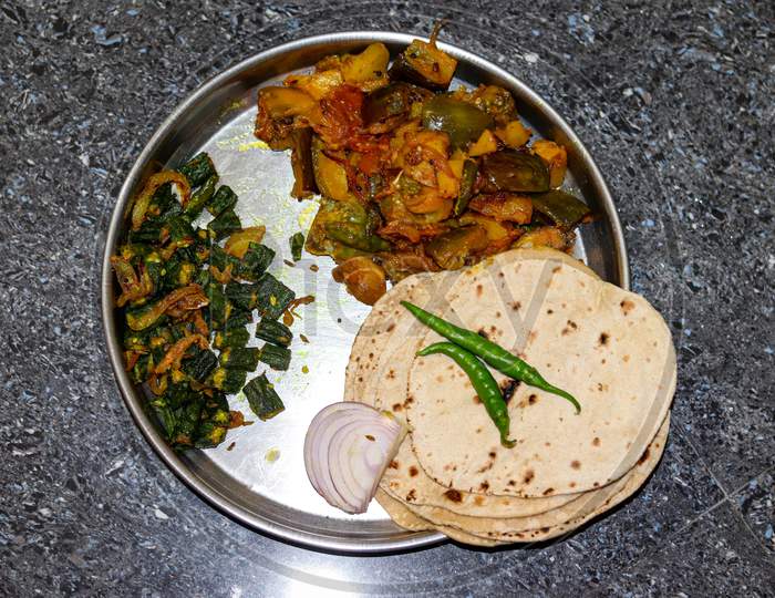 Roti with potato and brinjal and lady finger fry