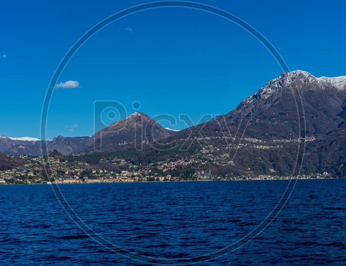 Italy, Bellagio, Lake Como With Snow Capped Alps Mountain