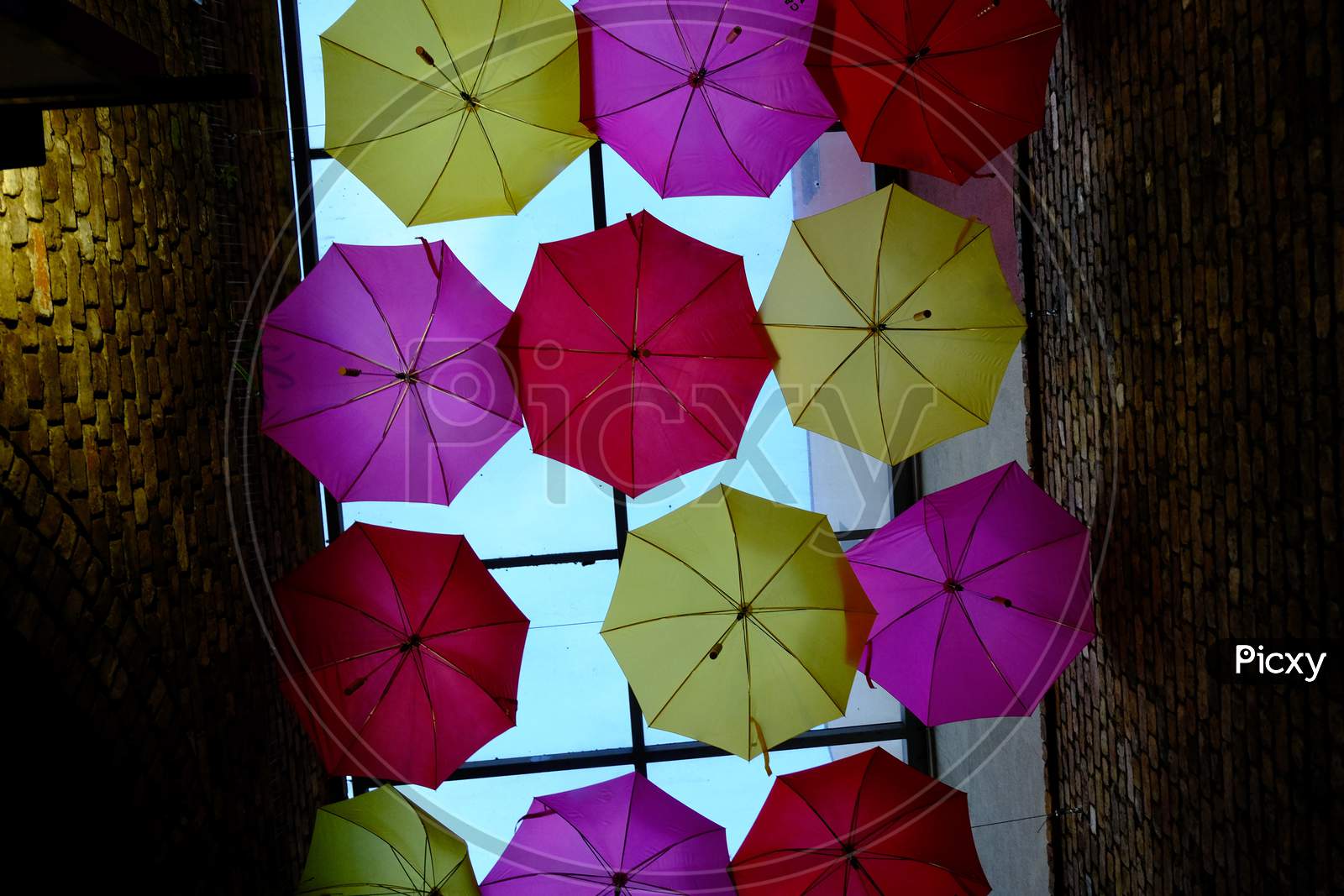 Colourful umbrellas in a moody alleyway