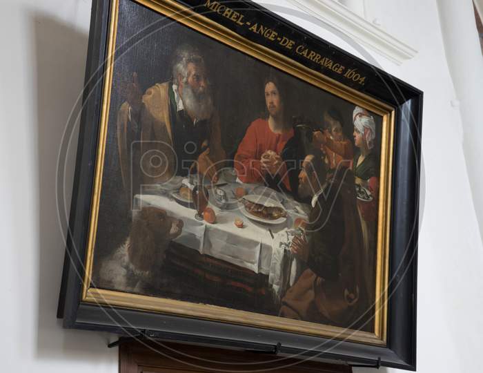 Bruges, Belgium - 16 April 2017: A Caravaggio Painting Of A Supper With Jesus, Bruges, Belgium