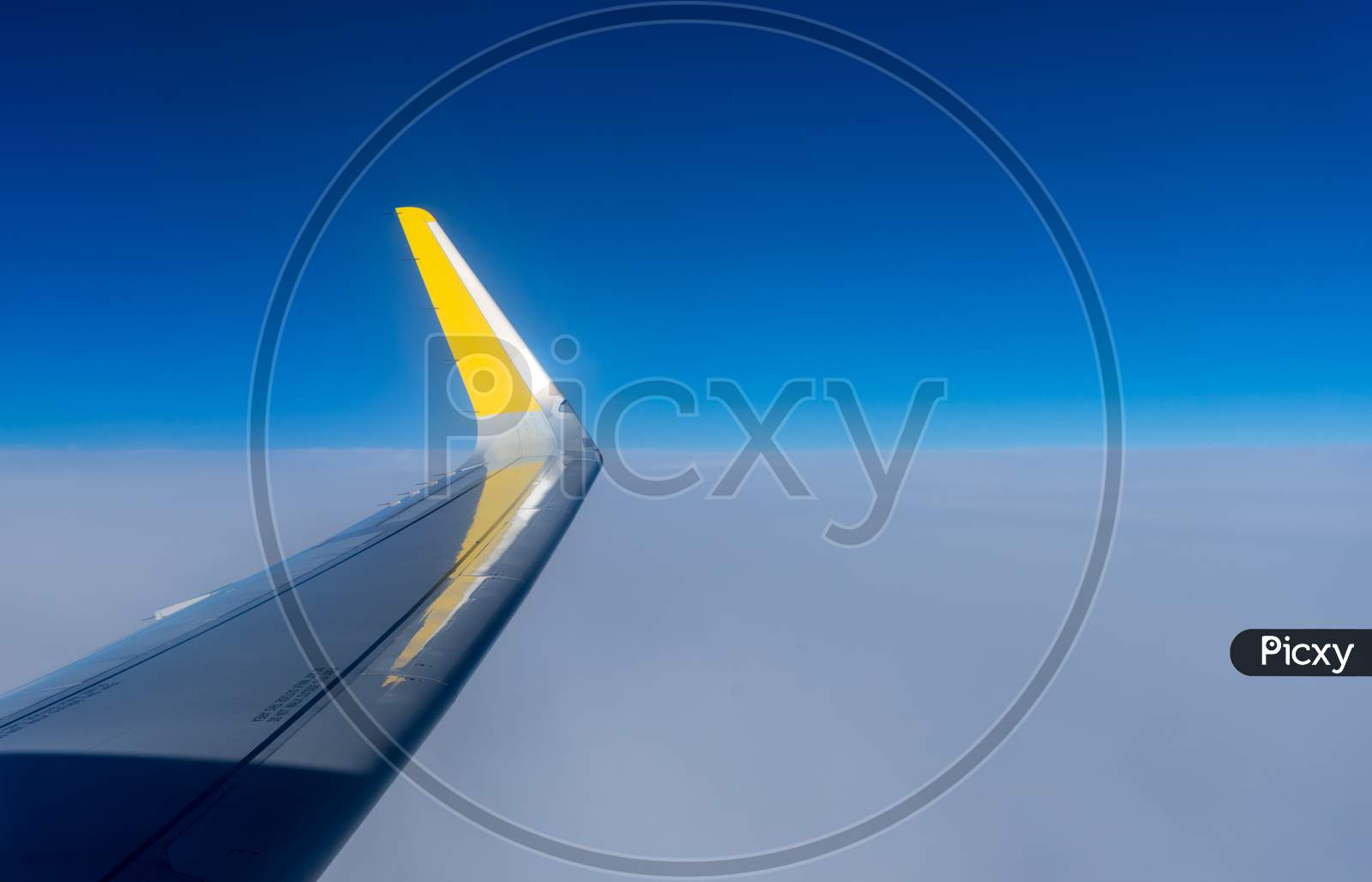 Netherlands, Hague, Schiphol, A Blue And Yellow Airplane Is Flying In The Sky