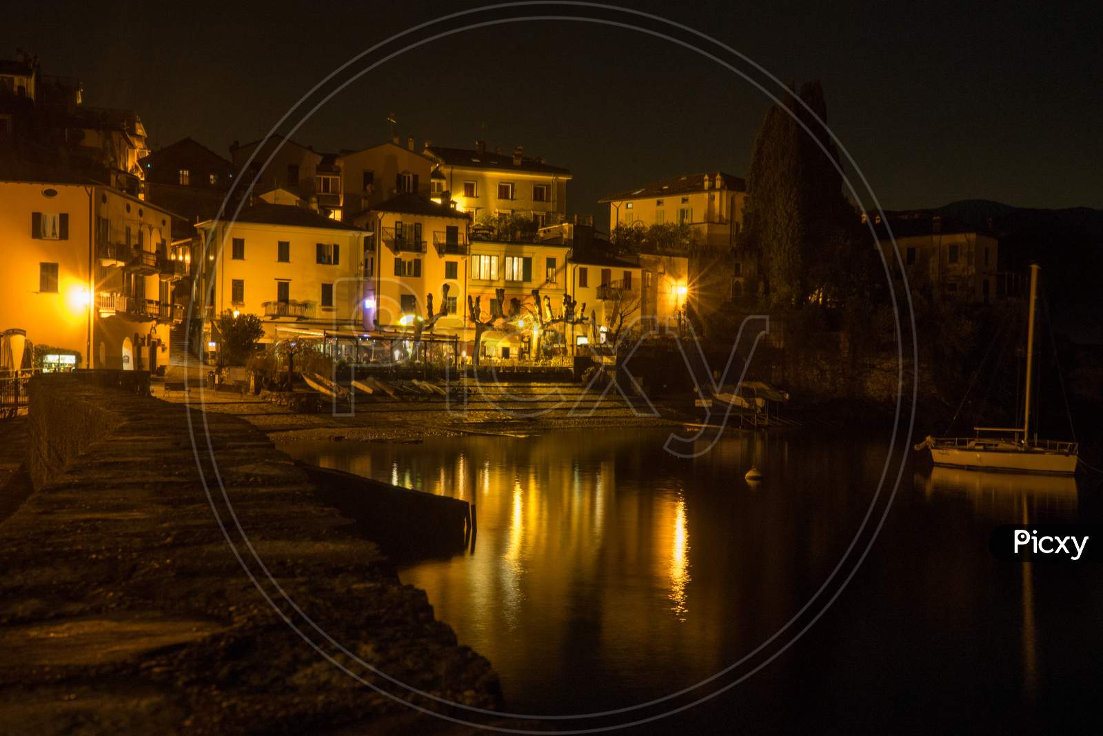 Italy, Varenna, Lake Como, A View Of A City At Night