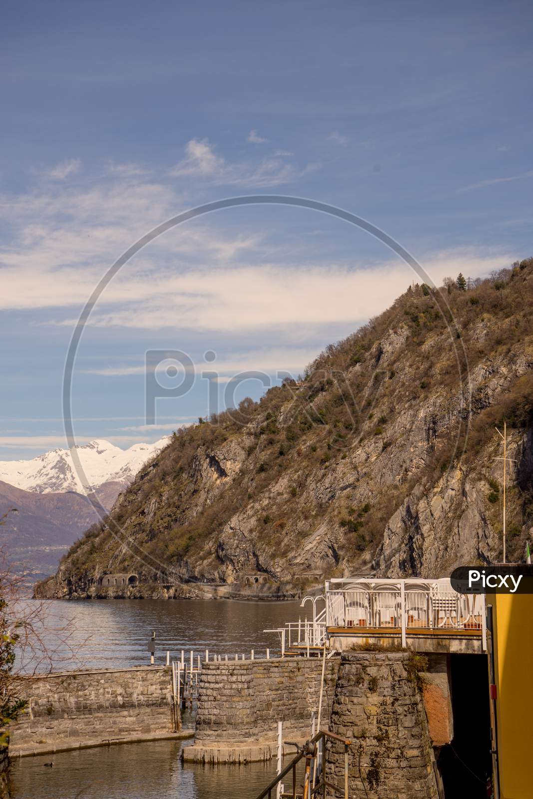 Italy, Menaggio, Lake Como, A Bridge Over A Body Of Water