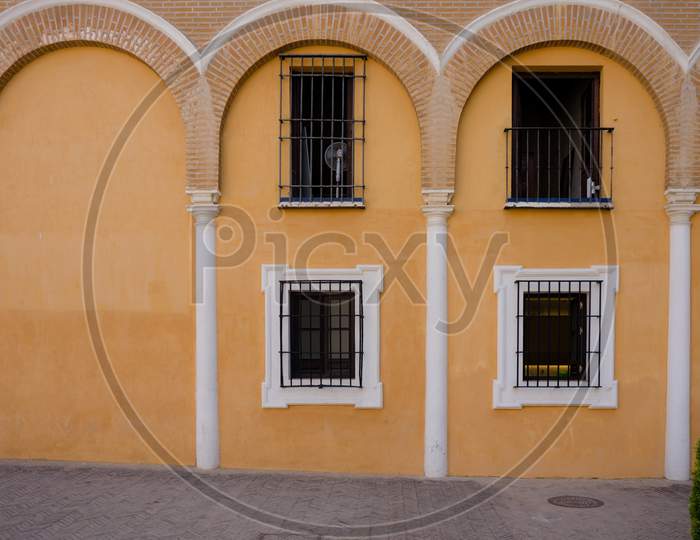 Yellow Arches Above The Balcony Window In Seville, Spain, Europe