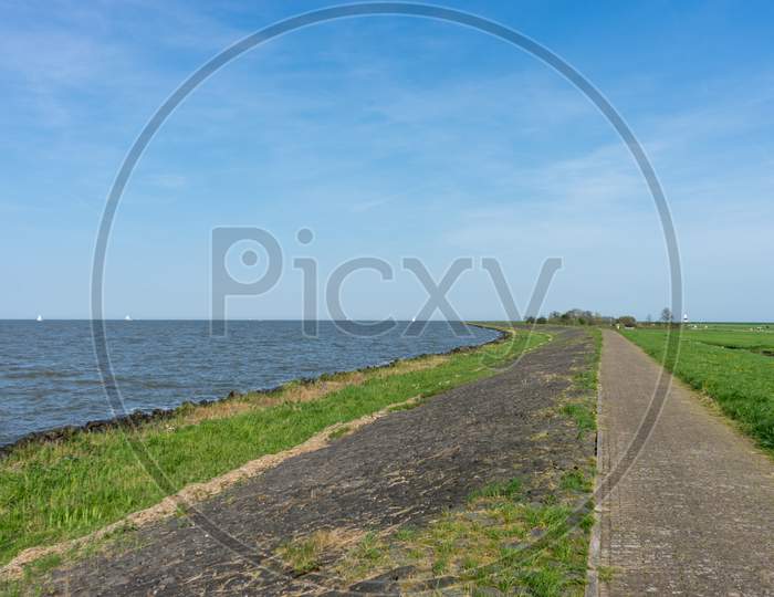 Netherlands,Wetlands,Maarken, Road By Sea Against Sky