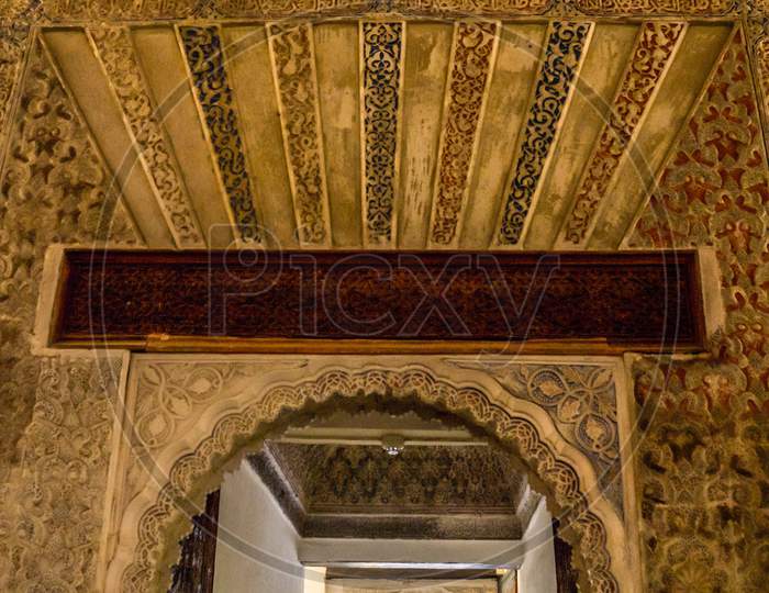 Seville, Spain- June 18, 2017 : Intricate Arabic Moorish Design Is Displayed Over An Arch At The Alcazar Palace In Seville, Spain June 2017.
