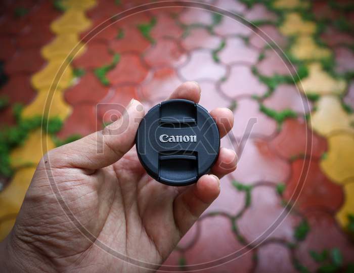 Ujjain, India - August 15Th 2020: Canon Lens Cap With Blur Background. Canon Logo.