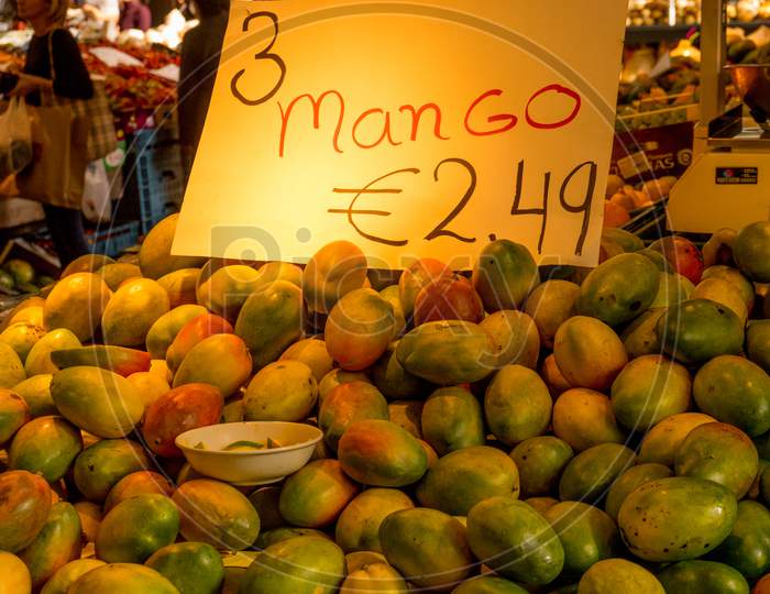 Netherlands, Rotterdam, A Group Of Mango Fruit On Display In A Store