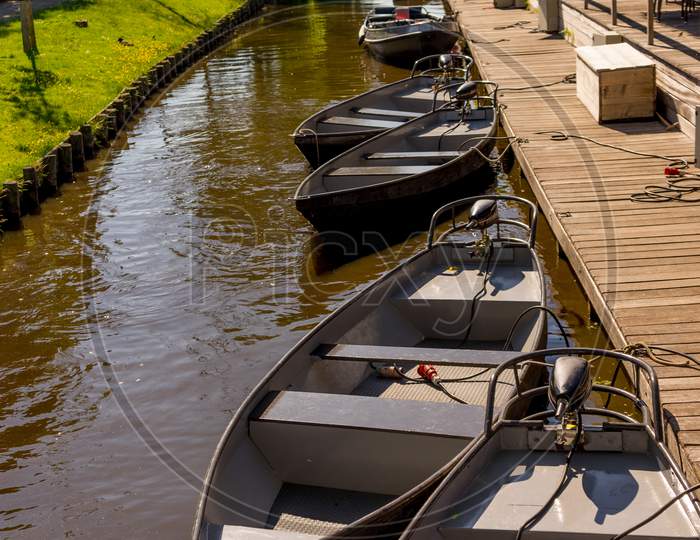 Netherlands, Giethoorn, A Boat Is Docked Next To A River