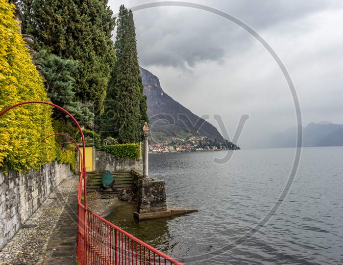 Italy, Varenna, Lake Como, A Bridge Over A Body Of Water