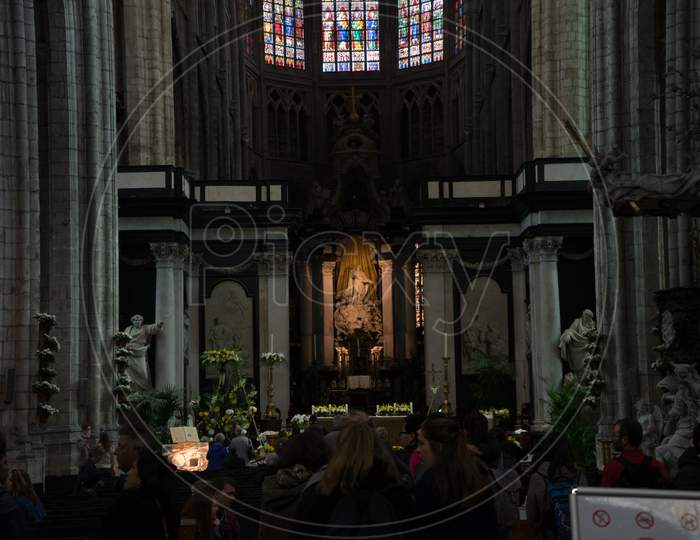 Ghent Belgium - April 15 : The Prayer At Tthe Altar Of The St.Nikolas Church In In Ghent, Belgium