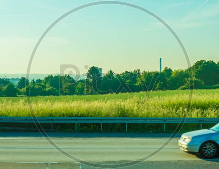 Germany, Frankfurt, Sunrise, A Car Parked On The Side Of A Road