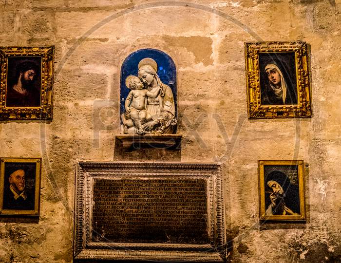Seville, Spain- June 18, 2017: Artifacts On The Wall Inside The  Gothic Cathedral In Seville, Spain June 2017