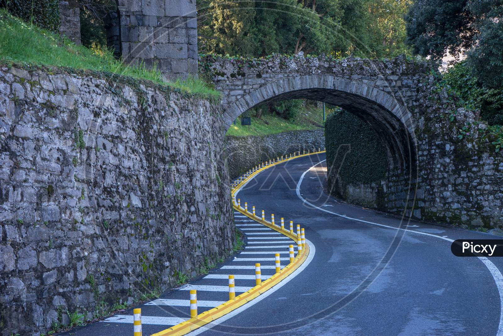 Italy, Bellagio, Lake Como, Winding Road Road Passing Through An Arch Curve