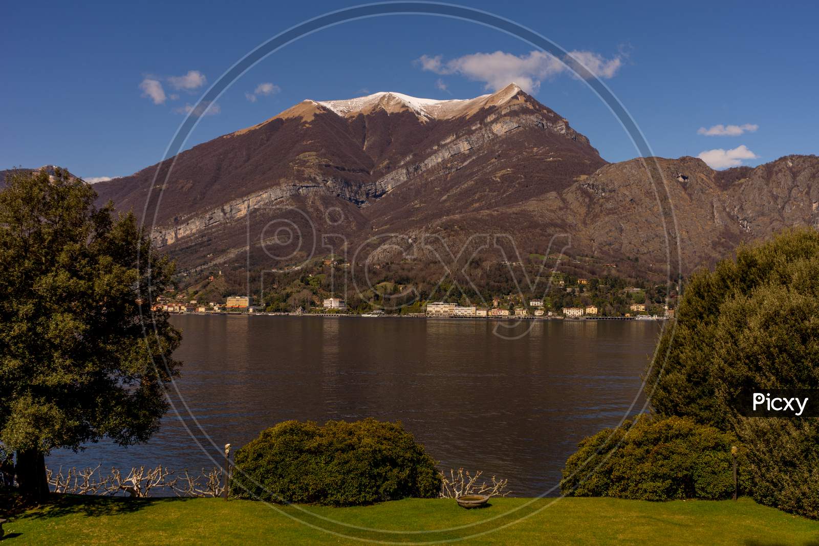 Italy, Bellagio, Lake Como, Scenic View Of Snowcapped Mountains Against Blue Sky, Lombardy