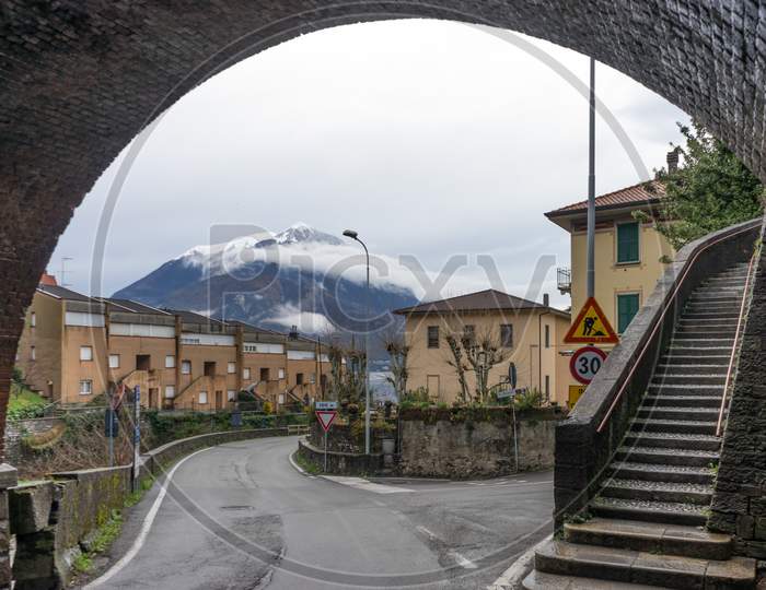 Italy, Varenna, Lake Como, Mountain Viewed Under An Arch