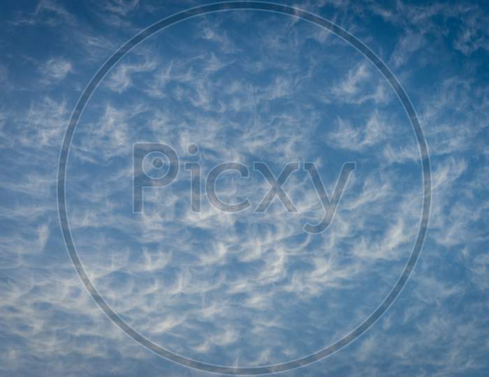 Clouds In The Shape Of Angels Float Across A Blue Sky In Malaga, Spain, Europe