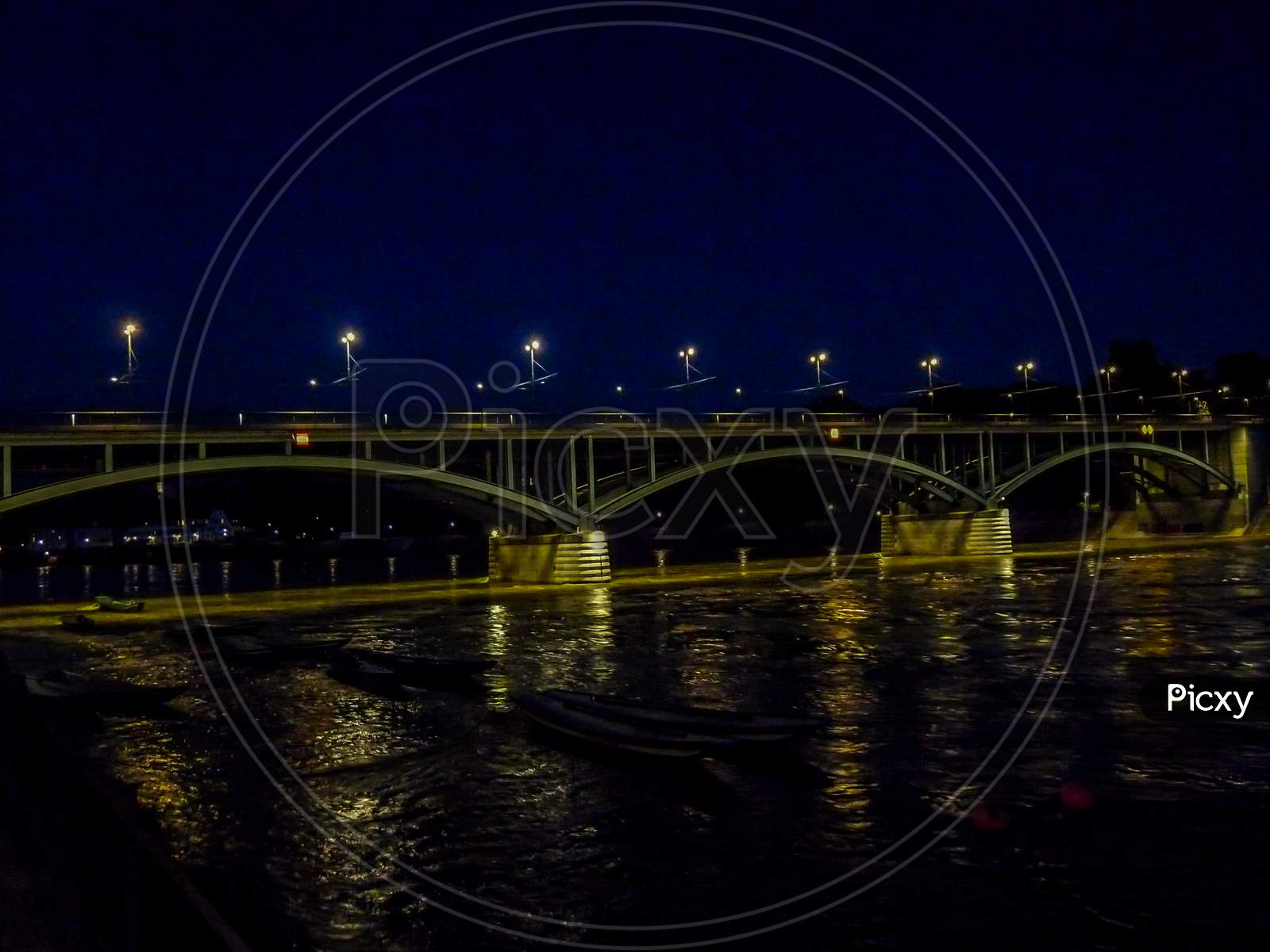 Switzerland, Basel, Illuminated Bridge Over Rhine River Against Sky In City At Night