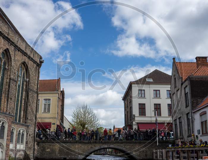 Bruges, Belgium - 16 April 2017: Tourists Waiting For Their Turn For A Boat Ride In Bruges, Belgium
