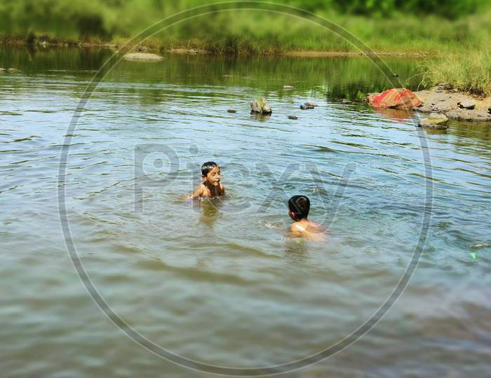 Children are playing in river water