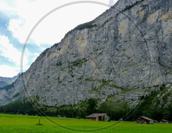 Switzerland, Lauterbrunnen, Scenic View Of Field By Mountains Against Sky