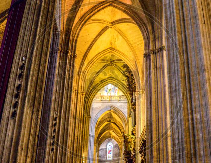 Seville, Spain- June 18, 2017: A Pillar And Arch Inside The  Gothic Cathedral In Seville, Spain June 2017