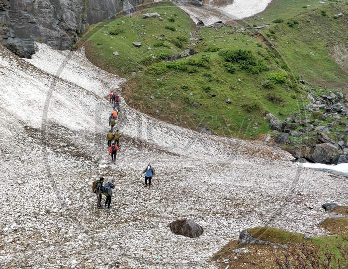 Manali, India - June 12Th 2019: Group Of Hikers In A Trekking Group Climbing On A Slippery Glacial Valley To Reach Indian Himalayan Mountain Top.