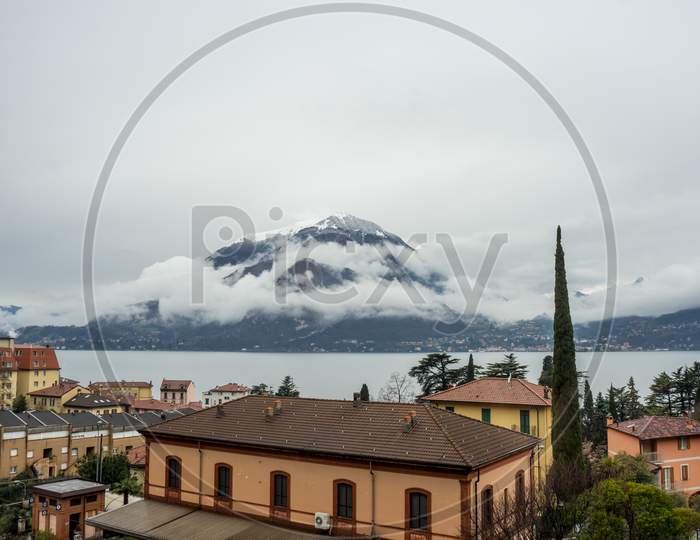Italy, Varenna, Lake Como, A Large Body Of Clouds Covering Mountain