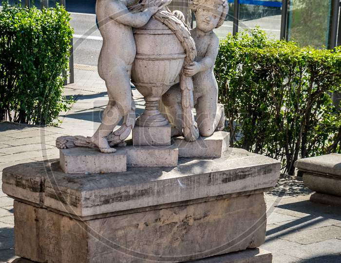 White Marble Sculpture Of 2 Children Holding A Water Pot In Madrid, Spain, Europe