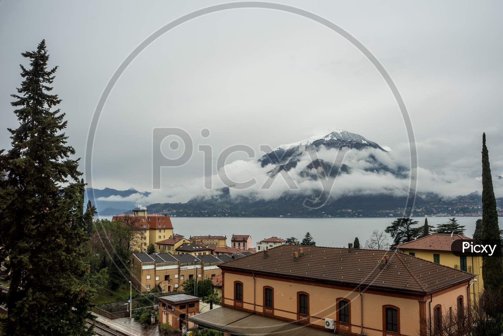 Italy, Varenna, Lake Como, A Large Body Of Clouds Covering Mountain