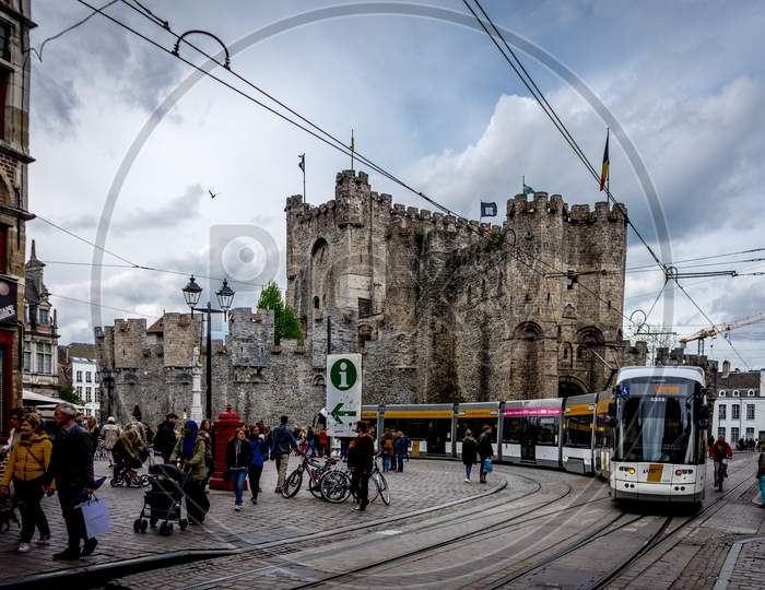 Ghent, Belgium - April 15 :  The Gravensteen Castle In Ghent, Belgium. A Tram Passes By In Front Of The Castle