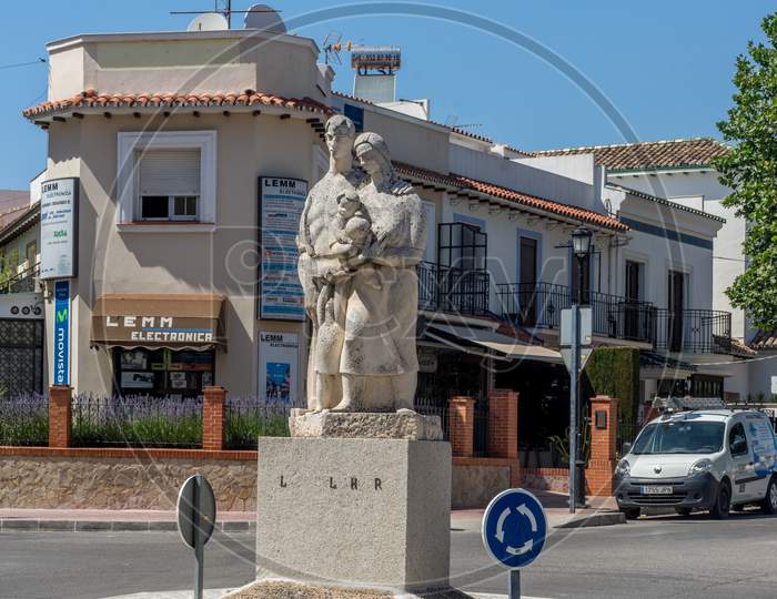 Spain, Ronda - 21 June 2017: Statue Of A Family In A Neighbourhood