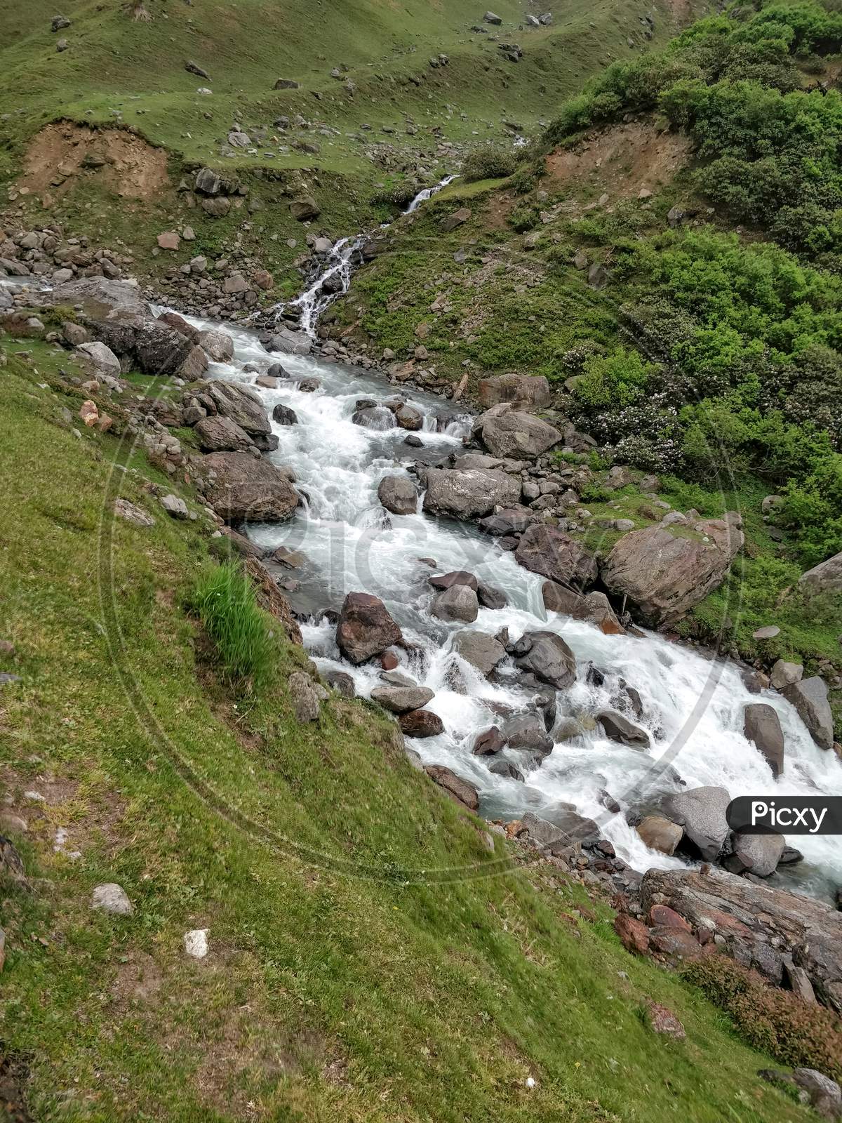 Beautiful River Stream Flowing Through Rocks In Indian Himalayan Mountain Valley.