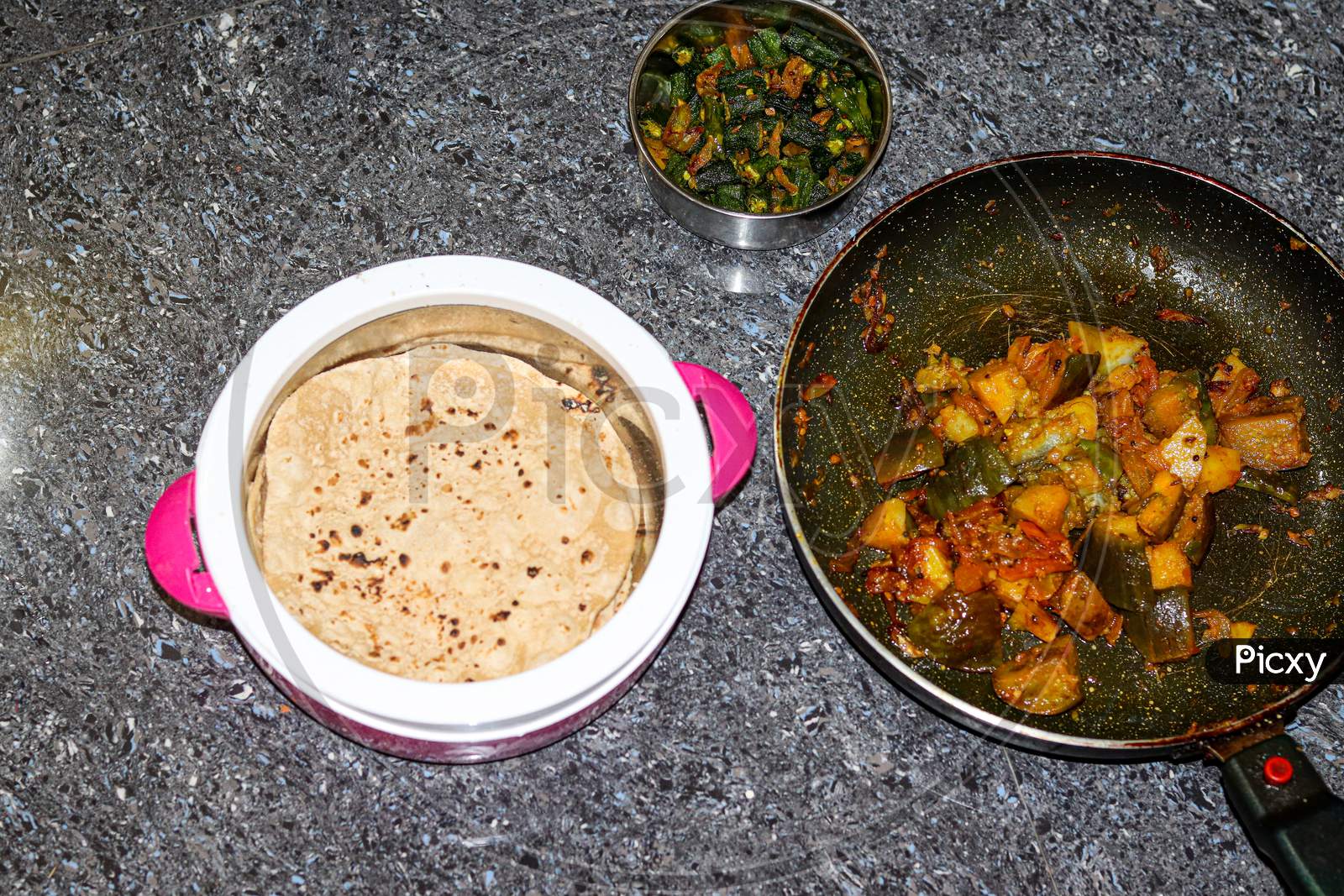 Roti with potato and brinjal and lady finger fry