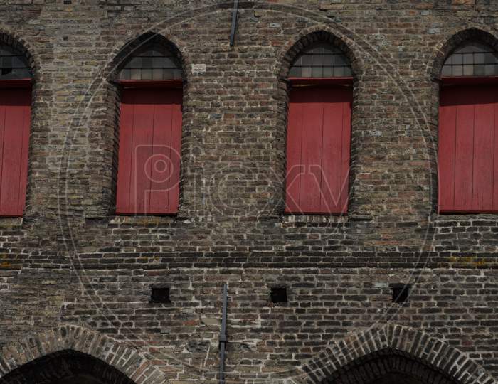 Window With A Arch On A Red Brick Wall