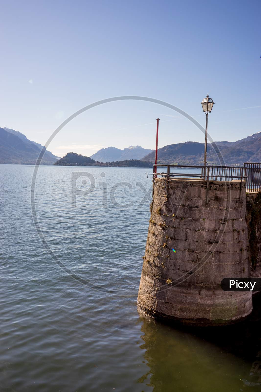 Italy, Menaggio, Lake Como, A Small Boat In A Body Of Water
