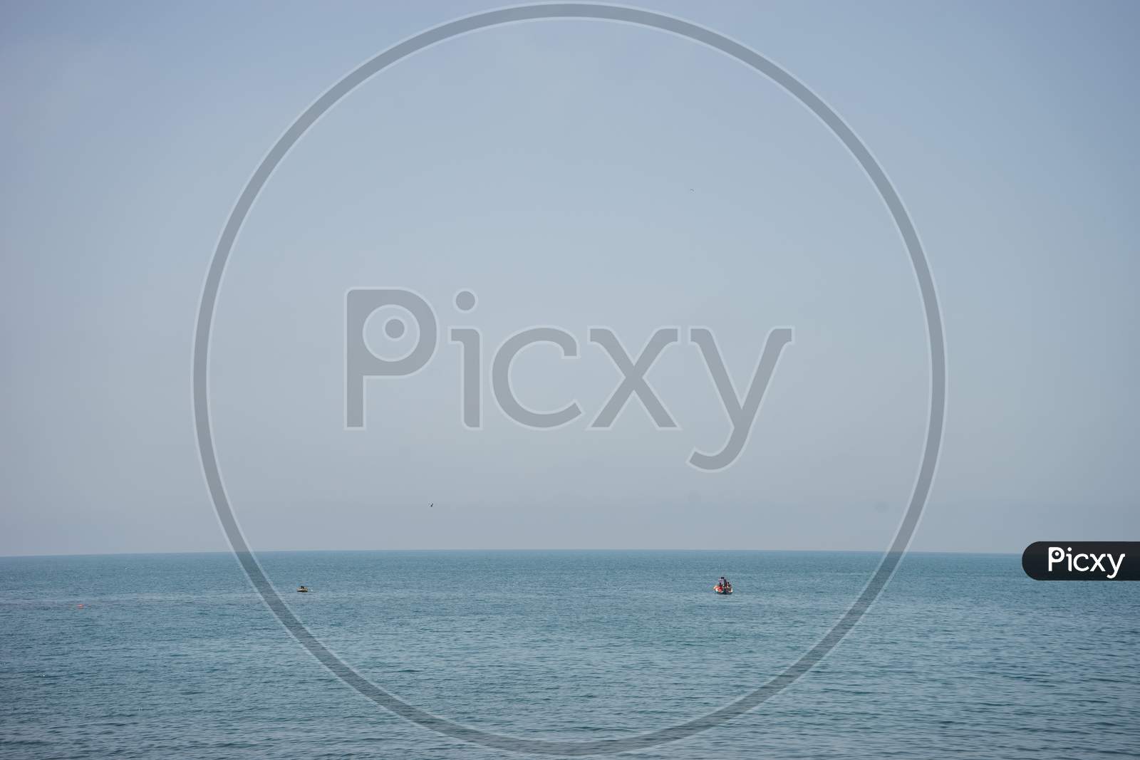 Calm And Serene Ocean  With A Lonely Boat At Malaga, Spain, Europe With Clear Sky