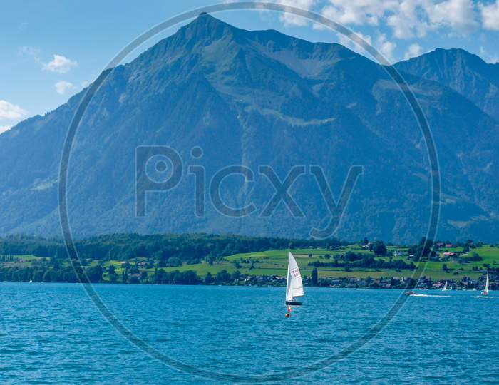 Switzerland, Lauterbrunnen, Sailboat In Sea Against Mountains
