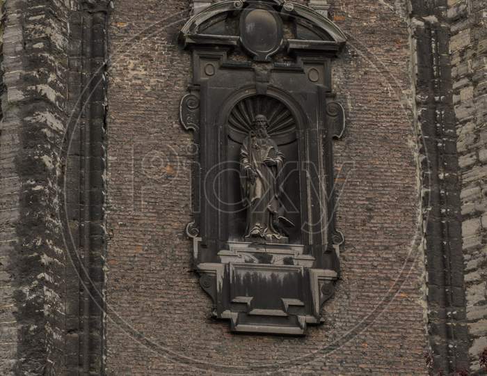 A Sculpture Of A Saint With A Swan At The Heel Shown On A Wall Of A Building In Ghent, Belgium