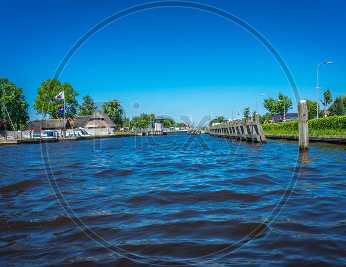 Netherlands, Giethoorn, A Pool Next To A Body Of Water